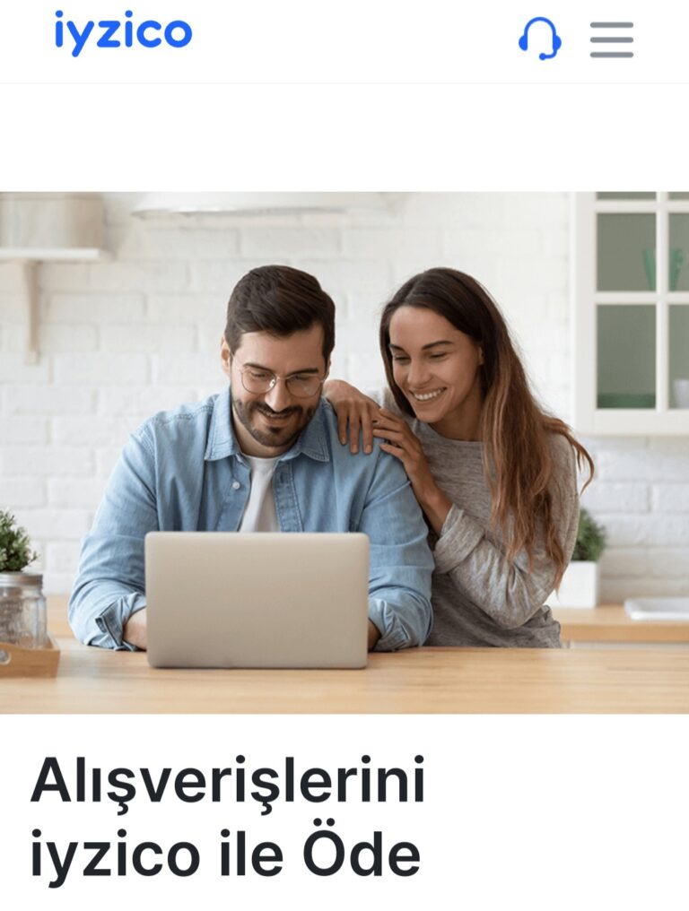 Bir erkek ve bir kadın, bilgisayar ekranına bakarak gülümseyen bir şekilde oturuyor.